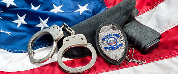 bigstock-Police-badge-gun-and-handcuff-36354937