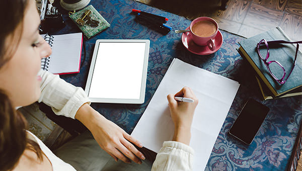 bigstock-Woman-Writing-And-Working-At-H-88939259