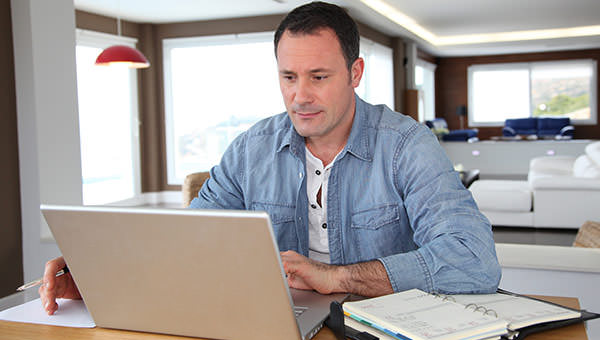 bigstock-Man-working-at-home-on-laptop--17009636