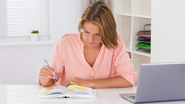 bigstock-Woman-Writing-Schedule-In-Diar-102661226