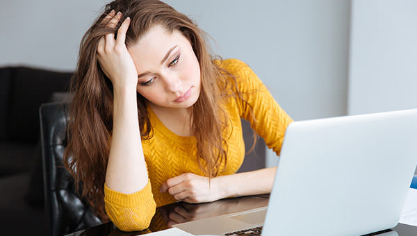 bigstock-Sad-woman-sitting-at-the-table-116054498