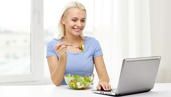 bigstock-smiling-woman-with-laptop-eati-113252099