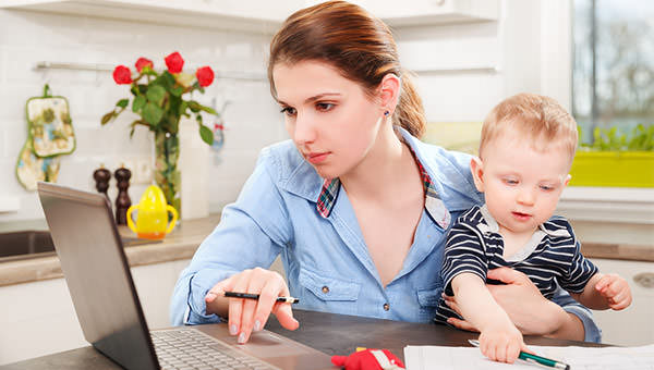 bigstock-Young-mother-working-with-her--119546201