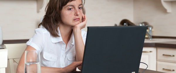 Bored and tired business person working at home