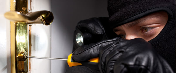 bigstock-Thief-Burglar-opening-door-53815426