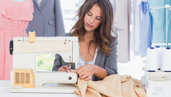 Fashion designer sewing with sewing machine