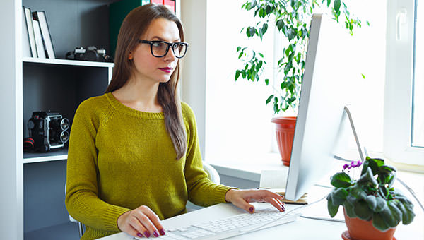 bigstock-Beautiful-Young-Woman-Working--110776826