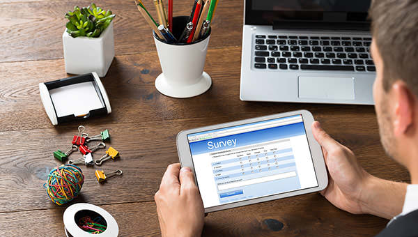 bigstock-Businessman-Looking-At-Survey--104964074