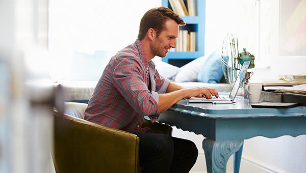 bigstock-Man-At-Desk-Working-In-Home-Of-92385725