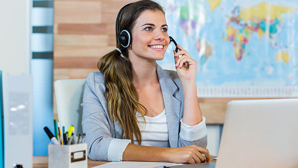 bigstock-Pretty-travel-agent-speaking-t-93647012
