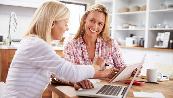 bigstock-Two-women-working-together-at--92385899