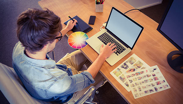 bigstock-Happy-designer-working-on-his--91317590